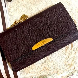 Henri Bendel wallet on chain crossbody bag in maroon cooor with gold touch.